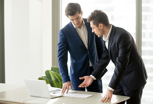 Two Professionals discussing how to Migrate from AS400